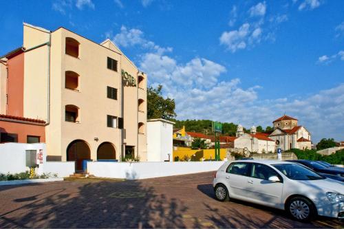 a car parked in a parking lot next to a building at Hotel Skradinski Buk in Skradin