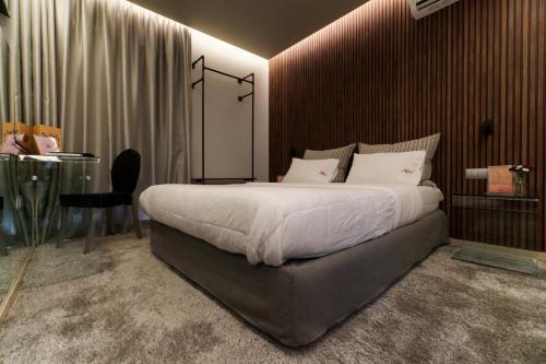 a bedroom with a large bed and a desk and a table at X Dream Hotel-Adults Only in Athens