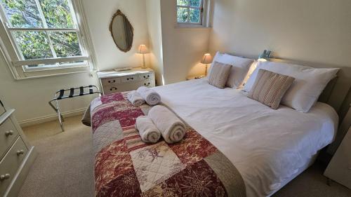 a bedroom with a large bed with towels on it at Pennant in Saint Mawes