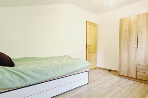 a white bedroom with a bed and a closet at Le Rocher YourHostHelper in Fontanil-Cornillon