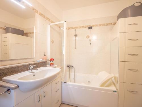 a bathroom with a sink and a tub and a shower at Babyaccommodation Family Hills in Magliolo
