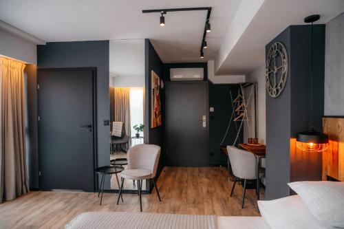 a bedroom with blue walls and chairs and a table at SLEEP WELL 1999 in Tychy