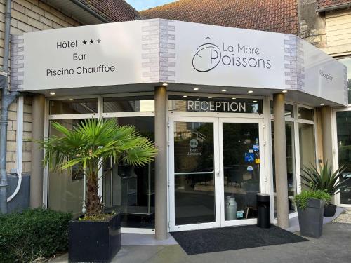 uma frente de loja com um sinal para uma loja em Hotel Best Western La Mare O Poissons em Ouistreham