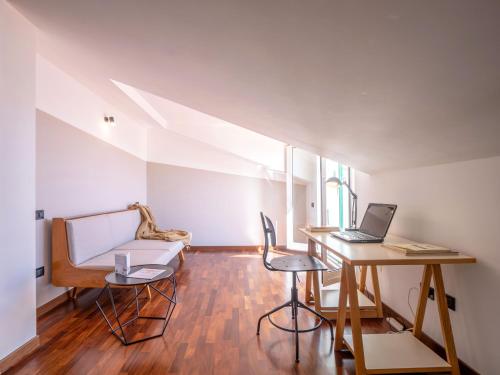 a room with a desk and a laptop on a table at Babyaccommodation Family Hills in Magliolo