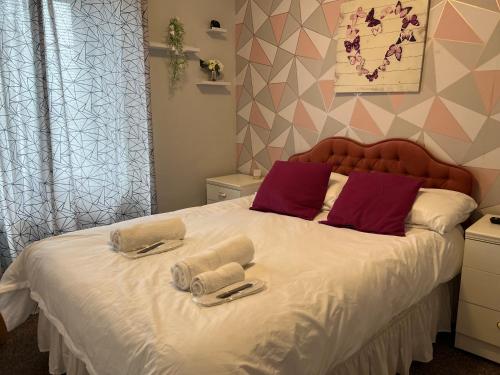 a bedroom with a large bed with towels on it at Modern Rooms with SELF Check-In The Castle, Coldstream in Coldstream