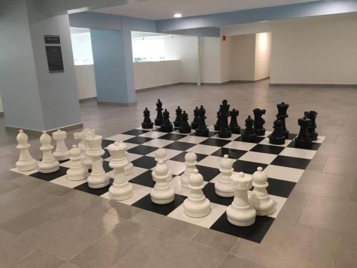 a chess board with a lot of chess pieces on it at New! Batu Ferringhi Seaview Cozy Condo, Penang in Batu Ferringhi