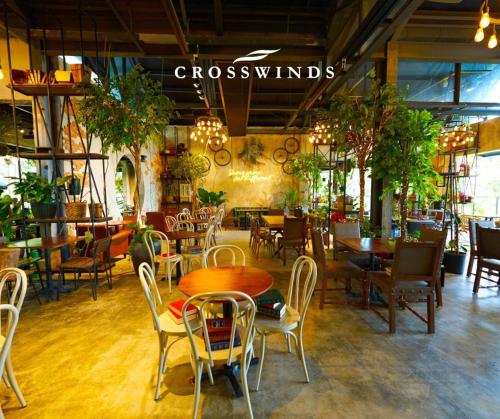 a restaurant with tables and chairs and a sign that reads crosswind at Alpine Breeze at Crosswinds Tagaytay in Tagaytay