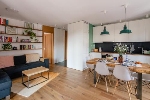 salon z niebieską kanapą i stołem w obiekcie Nadwiślańska11 - Klimatyczny apartament tuż nad Wisłą w Krakowie