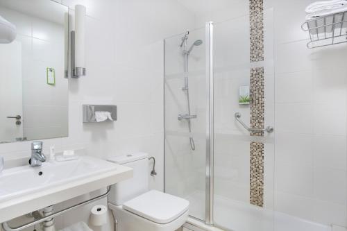 a bathroom with a shower and a toilet and a sink at Royal Sunset Beach Club in Adeje