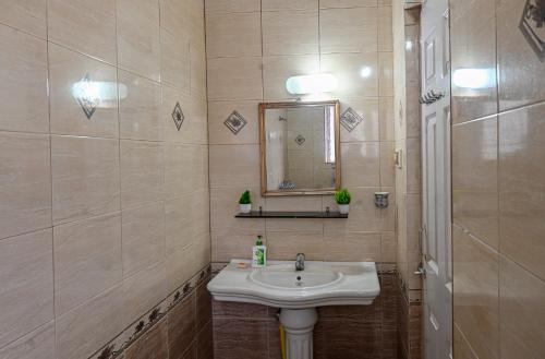 a bathroom with a sink and a mirror at 3bhk Duplex Villa With Pool In Candolim by GRStays in Candolim
