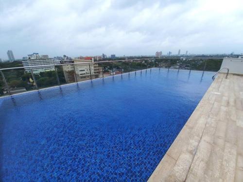 a large swimming pool on the roof of a building at Capital TRUST Residencies Colombo 05 in Colombo