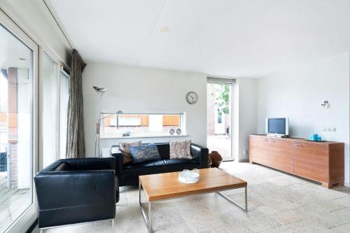 a living room with a couch and a coffee table at Boathouse Suburban Amsterdam in Uitgeest