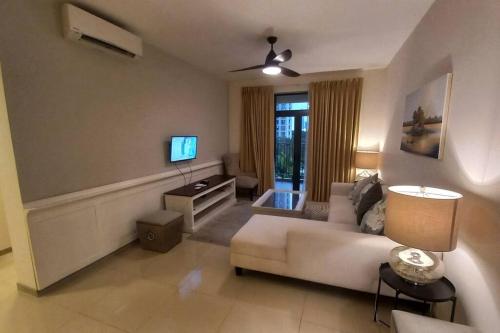 a living room with a white couch and a tv at Havelock City Edmonton Tower Colombo 05 in Colombo