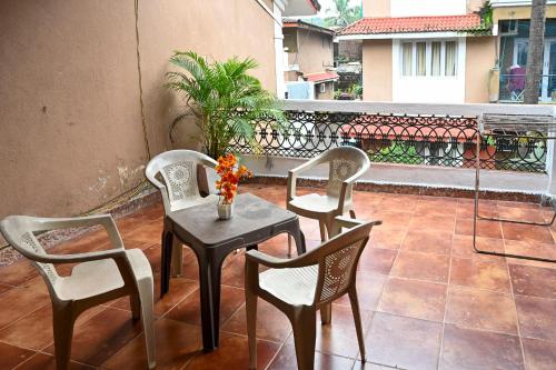 a group of chairs and a table on a balcony at 3bhk Duplex Villa With Pool In Candolim by GRStays in Candolim