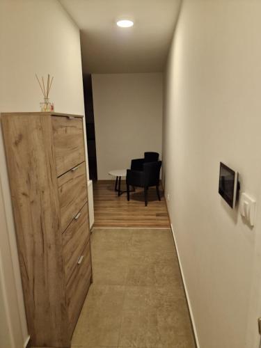 a hallway with a door and a table in a room at Stan na dan, Loznica in Loznica