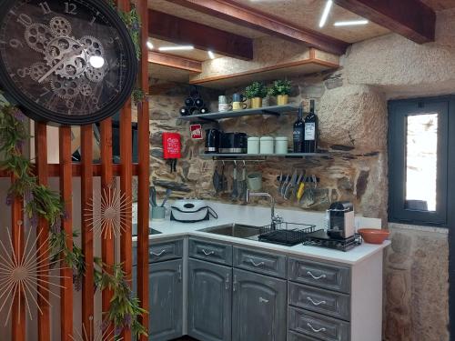 a kitchen with a sink and a counter top at Ribança Village in Destriz