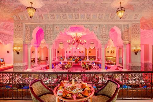 a dining room with a table and chairs in a building at Pickalbatros Palace - Aqua Park Hurghada in Hurghada