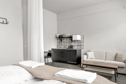 a living room with a bed and a couch at The Swan House by Heimaleiga in Reykjavík