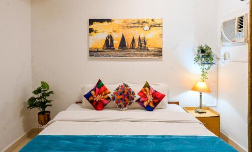 a bedroom with a bed with two pillows on it at 3bhk Duplex Villa With Pool In Candolim by GRStays in Candolim