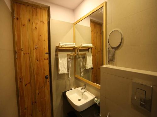 a bathroom with a sink and a mirror at D's Casa - A Unique Spanish Boutique House in McLeod Ganj