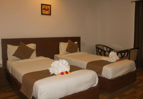 Postel nebo postele na pokoji v ubytování Hotel Peacock Pride