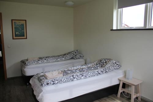 Una cama o camas en una habitación de Ljósavatn Guesthouse