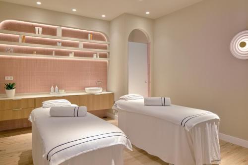 a room with two beds and a sink at Melia Jardines del Teide - Adults Only in Adeje
