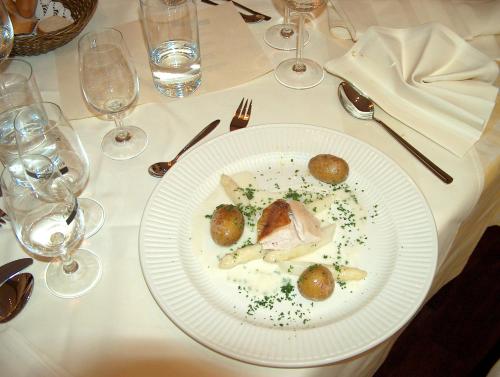 a white plate with food on a table at Zur Windmühle Restaurant - Hotel in Beckum