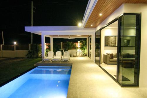 a swimming pool in the backyard of a house at night at Luxury Mango Villa in Bophut 