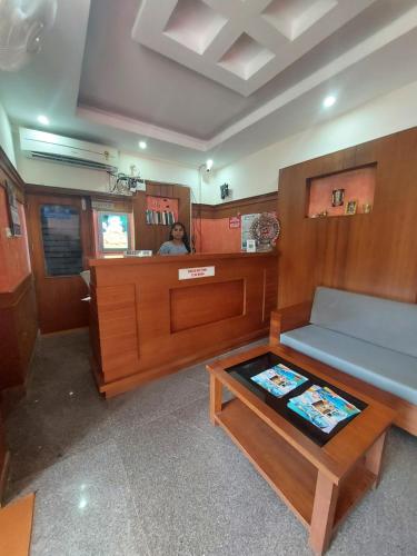 a room with a bench and a table in a boat at Padmatheertham Inn in Varkala