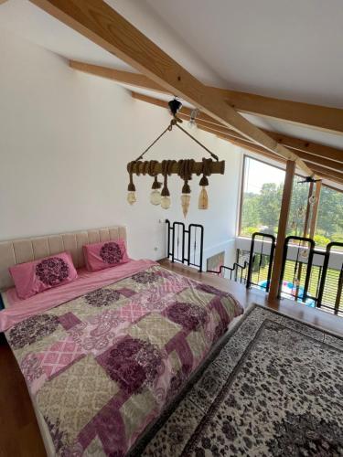 a bedroom with a bed in a room with windows at Villa fg in Gjilan