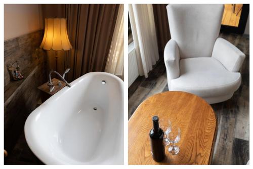 a bathroom with a tub and a chair and a table at Honeymoon Apartments in Old Tbilisi in Tbilisi City