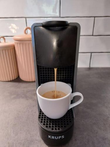 a coffee maker is making a cup of coffee at Mountain Lodge Studio Forset View in Szklarska Poręba