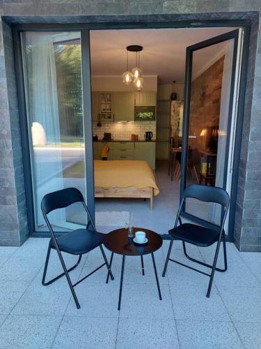 a room with two chairs and a table and a bedroom at Mountain Lodge Studio Forset View in Szklarska Poręba