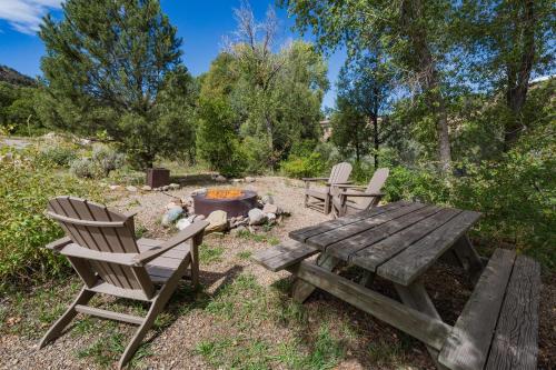 a picnic table and chairs next to a fire pit at CR 213 - 2 Bedroom in Durango
