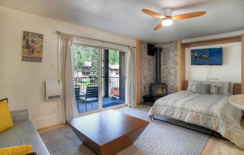 a bedroom with a bed and a living room at Studio Purgatory Townhome 111 in Durango Mountain Resort