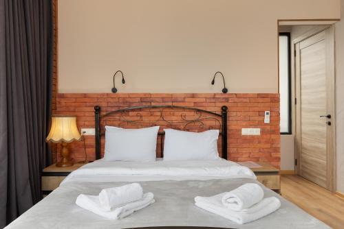 a bedroom with a bed with two towels on it at Honeymoon Apartments in Old Tbilisi in Tbilisi City