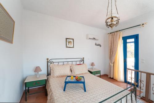 a bedroom with a bed with a blue table on it at Irene's house in Lachania