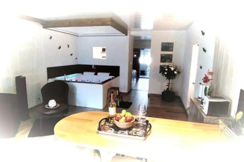 a living room with a table with a bowl of fruit at RÊVE POUR DEUX in Sampans