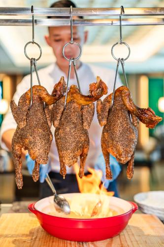 a bunch of bacon hanging from a rack in a bowl at DoubleTree by Hilton Shanwei in Shanwei