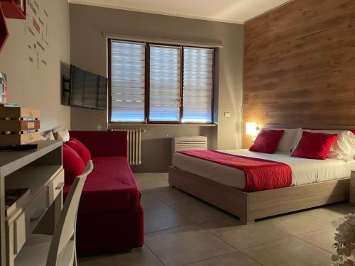 a bedroom with a large bed and a window at HappyHome Monolocale Rivarolo Canavese in Rivarolo Canavese