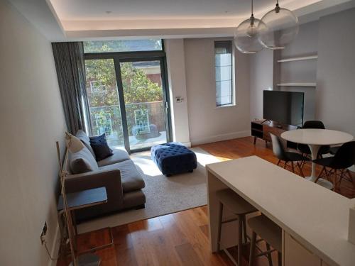 a living room with a couch and a table at Grays Inn by Aeria Apartments in London