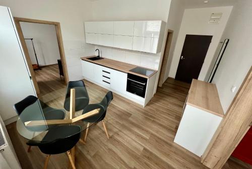 a kitchen with a table and two chairs and a counter at Sušilova 14 apartments III in Přerov