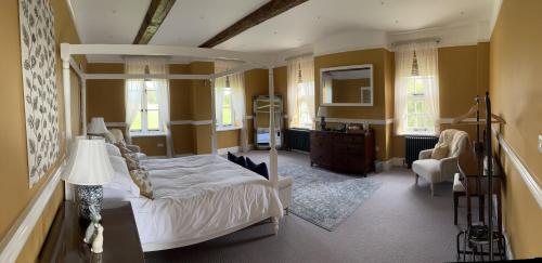 a bedroom with a canopy bed and a living room at Winsley Park Farm in Leominster