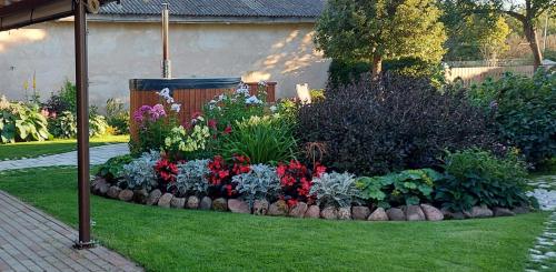a garden with colorful flowers in a yard at Apartamenti Dundaga XXL in Dundaga