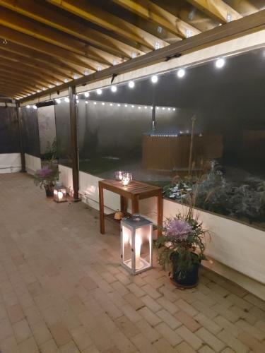 a patio with a table and lights on it at Apartamenti Dundaga XXL in Dundaga