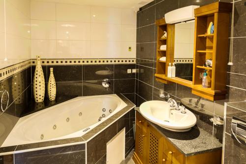 a bathroom with a tub and a sink at Like walking into a fantastic novel at Inishowen House in Rashenny