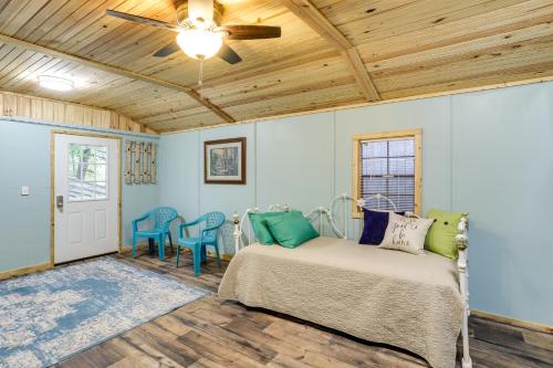 a bedroom with a bed and a ceiling fan at Peaceful Alton Vacation Rental with Grill! 