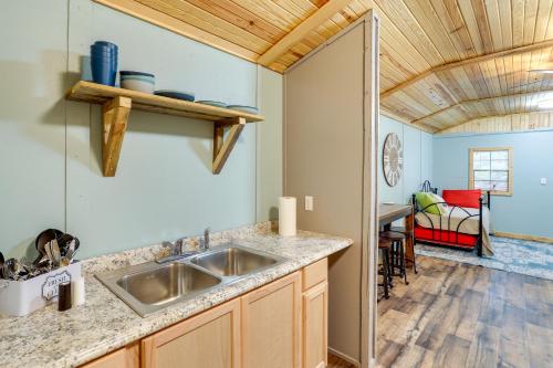 a kitchen with a sink and a dining room at Peaceful Alton Vacation Rental with Grill! 