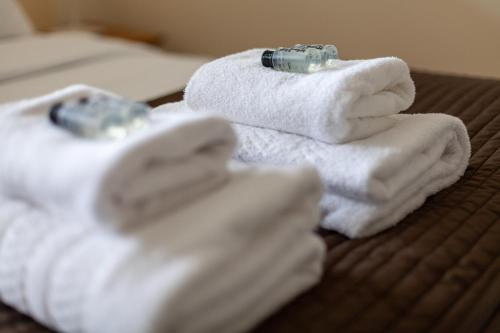 a pile of towels sitting on top of a bed at Quiet & Spacious 2BR Flat wGarden near Edmonton in Edmonton